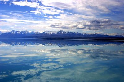 Scenic view of lake and mountains against sky