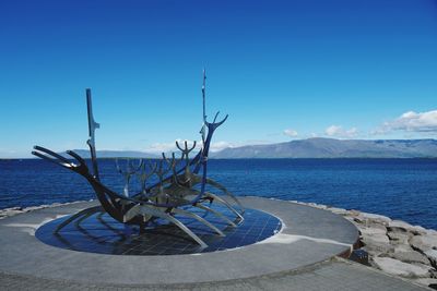 Scenic view of sea against blue sky