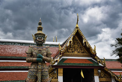 Giant yak, yaksha statue with large teeth, piercing eye with sword in hand