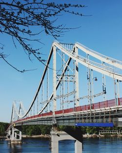 Low angle view of suspension bridge against sky