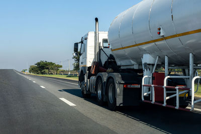 Vehicles on road against sky