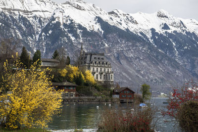 Scenic view of lake by mountains during winter