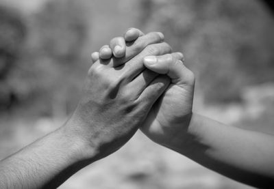 Cropped image of couple holding hands