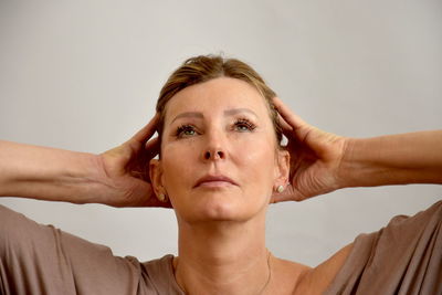 Portrait of mid adult woman against white background