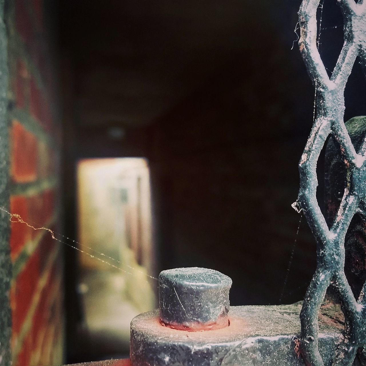 CLOSE-UP OF RUSTY METAL AGAINST WINDOW