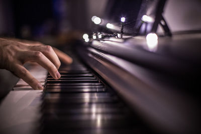 Midsection of person playing piano