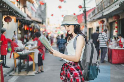 Woman standing on street in city