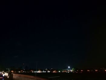 Illuminated buildings against sky at night