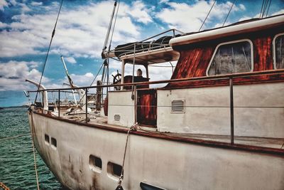 Sailboats moored on sea against sky