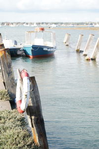 Boats moored on sea against sky