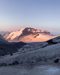 Scenic view of snowcapped mountains against clear sky during winter