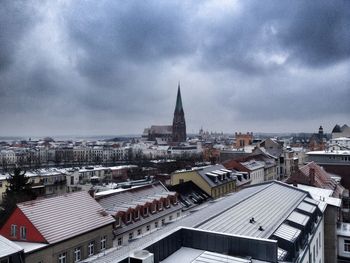 Cityscape against cloudy sky