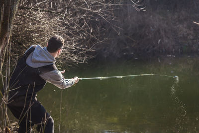 Boy fishing in lake