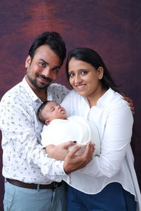 New born with his parents in white 