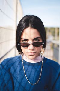 Portrait of woman wearing sunglasses while standing outdoors