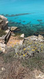 High angle view of rocks by sea