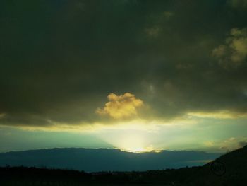 Scenic view of silhouette mountain against sky at sunset