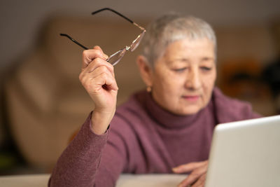 Young woman using laptop at table