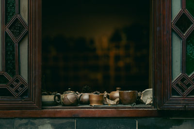 A windowsill with teapots and other utensils on it