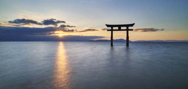 Long exposure shot of shirahige shrine torii gate at sunrise, lake biwa, shiga prefecture, japan