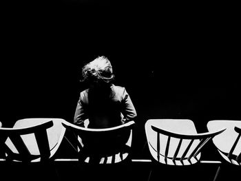 Man sitting on table against black background