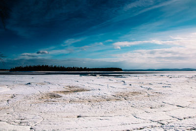 Scenic view of beach against blue sky