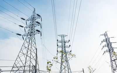 Low angle view of electricity pylon against sky