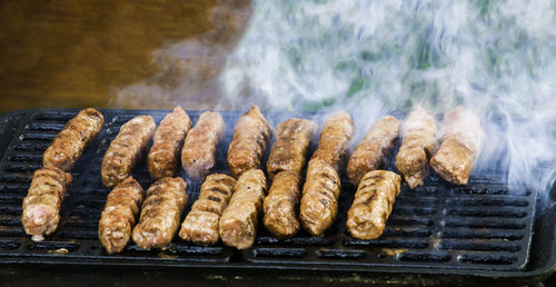 High angle view of meat on barbecue grill