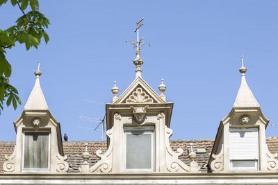 Low angle view of church and building against sky