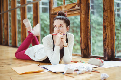 Portrait of a young woman sitting on table