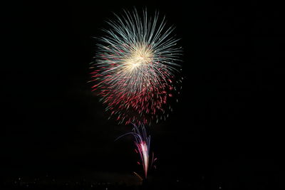 Low angle view of firework display at night