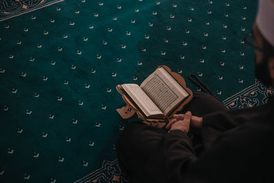 High angle view of man holding book