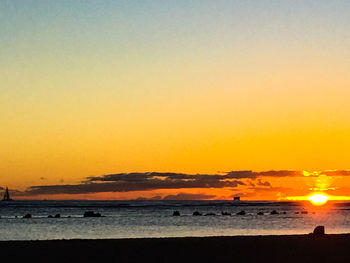 Scenic view of beach against sky during sunset