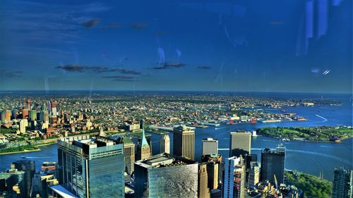 High angle view of city by sea against sky