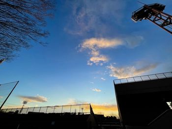 Low angle view of silhouette building against sky at sunset