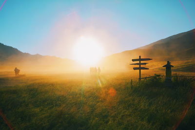 Scenic view of field against sky during sunset