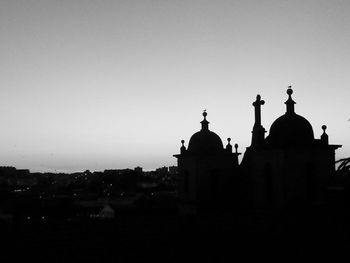 Silhouette traditional buildings against clear sky