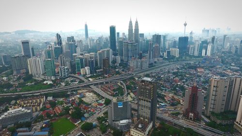 High angle view of modern buildings in city against sky