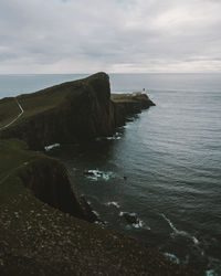 Scenic view of scottish highlands and sea against cloudy sky