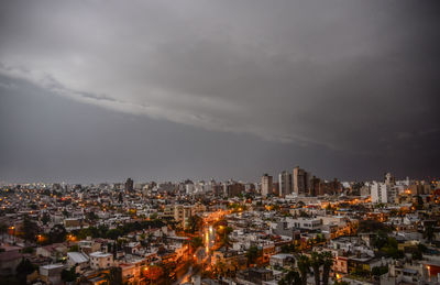 High angle view of illuminated buildings against sky at dusk