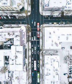 Aerial view of road amidst snow covered buildings in city