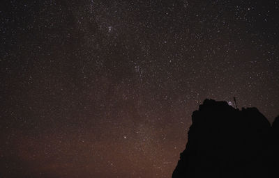 Low angle view of silhouette stars against sky at night