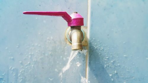 Close-up of faucet against white wall