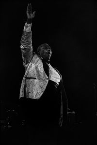 Low angle view of man standing against black background