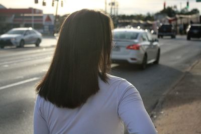 Rear view of woman standing in city
