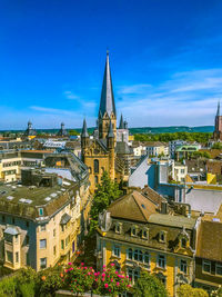 High angle view of buildings against blue sky