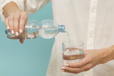 Midsection of man pouring water