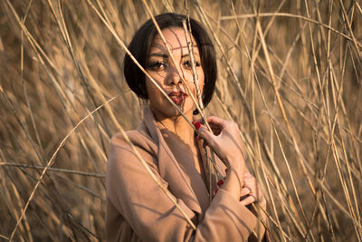 Portrait of woman standing by plants