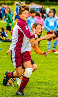 People playing soccer on field