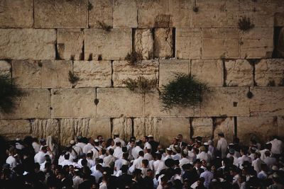 High angle view of people walking against wall